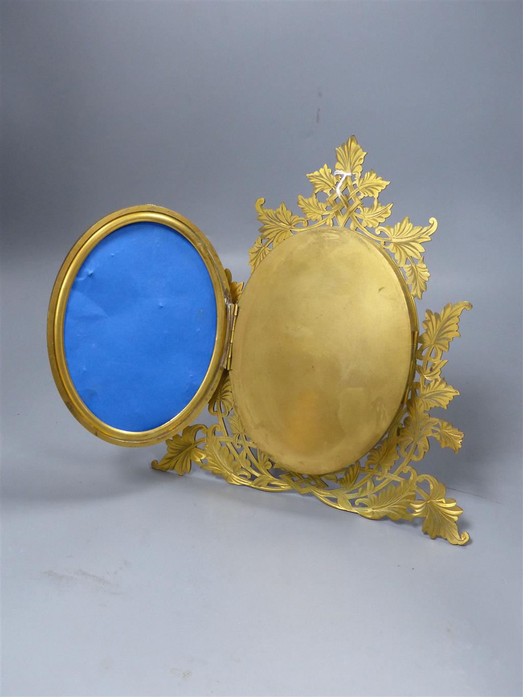 An ormolu triptych photograph frame with micro mosaic inlay